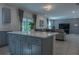 Open kitchen with island and view into living room at 3681 Magnolia Dr, Indian Lake Estates, FL 33855