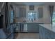 Modern kitchen with gray cabinets and stainless steel appliances at 3681 Magnolia Dr, Indian Lake Estates, FL 33855