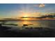 Scenic sunset over a tranquil lake with clouds at 3681 Magnolia Dr, Indian Lake Estates, FL 33855
