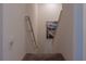 Upper level carpeted stairs with wall-mounted railing at 3681 Magnolia Dr, Indian Lake Estates, FL 33855