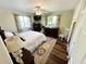 Bedroom with wood floors, ceiling fan, and a window overlooking the side yard at 1600 W Lake Parker Dr # A6, Lakeland, FL 33805