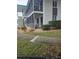 Low-rise building with manicured lawn, rock garden, and covered balconies with screened enclosures at 1600 W Lake Parker Dr # A6, Lakeland, FL 33805