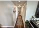 Hallway with laminated wood flooring and fresh paint that leads to the bedrooms at 1600 W Lake Parker Dr # A6, Lakeland, FL 33805