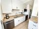 Bright kitchen featuring white cabinets, granite countertops, stainless steel appliances, and modern finishes at 1600 W Lake Parker Dr # A6, Lakeland, FL 33805