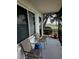 Relaxing screened porch with chairs, side table, and tranquil views of the lake at 1600 W Lake Parker Dr # A6, Lakeland, FL 33805