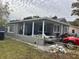 Gray house with covered porch and a fenced yard at 3910 W Robinson St, Orlando, FL 32805