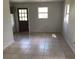 Simple living room with tile floor and door at 810 Avenue L Sw, Winter Haven, FL 33880