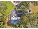 Overhead view of house, pool, and surrounding trees at 1614 King James Ct, Lakeland, FL 33813