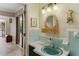 Simple bathroom with light blue tile, single sink vanity, and a classic look at 1614 King James Ct, Lakeland, FL 33813