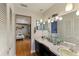 Bright bathroom with double vanity and view into bedroom at 1614 King James Ct, Lakeland, FL 33813