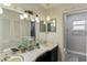 Bathroom with double vanity, updated shower, and linen closet at 1614 King James Ct, Lakeland, FL 33813