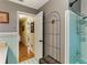 Bathroom with teal tile, tub, and view into hallway at 1614 King James Ct, Lakeland, FL 33813