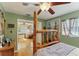 Bedroom with rustic bed frame and view into sitting area at 1614 King James Ct, Lakeland, FL 33813