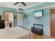 Serene bedroom with light blue walls, ceiling fan, and a mounted TV at 1614 King James Ct, Lakeland, FL 33813