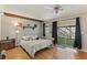 Spacious bedroom with hardwood floors, ceiling fan and access to a private patio at 1614 King James Ct, Lakeland, FL 33813