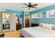 Cozy bedroom with light blue walls, a ceiling fan, and access to a private bathroom at 1614 King James Ct, Lakeland, FL 33813