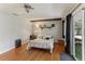 Bright bedroom with hardwood floors, ceiling fan, and access to a patio at 1614 King James Ct, Lakeland, FL 33813