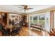 Bright dining room with hardwood floors, a large bay window, and a ceiling fan at 1614 King James Ct, Lakeland, FL 33813