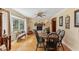 Sunlit dining area with hardwood floors, a round table and chairs, near a fireplace at 1614 King James Ct, Lakeland, FL 33813