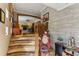 View of a unique wooden staircase and stone wall in the entryway at 1614 King James Ct, Lakeland, FL 33813