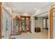 Bright entryway with glass-front cabinet, French doors, and tile flooring at 1614 King James Ct, Lakeland, FL 33813