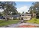 Ranch-style home with circular driveway and manicured lawn at 1614 King James Ct, Lakeland, FL 33813