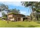 Mid-century ranch house with a large backyard and screened patio at 1614 King James Ct, Lakeland, FL 33813
