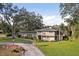 Mid-century modern home, two-car garage, mature landscaping at 1614 King James Ct, Lakeland, FL 33813