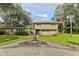 Two-story house with circular driveway, landscaping, and fountain at 1614 King James Ct, Lakeland, FL 33813