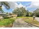 House with a circular driveway and well-manicured lawn at 1614 King James Ct, Lakeland, FL 33813