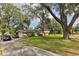 Ranch style home with a long driveway and mature trees at 1614 King James Ct, Lakeland, FL 33813