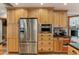 Modern kitchen with stainless steel appliances and light wood cabinets at 1614 King James Ct, Lakeland, FL 33813