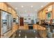 Modern kitchen with wood cabinets, granite countertops, and stainless steel appliances at 1614 King James Ct, Lakeland, FL 33813