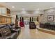 Living room with a stone fireplace, leather furniture, and pool view at 1614 King James Ct, Lakeland, FL 33813