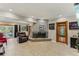 Living room with a stone fireplace, leather furniture, and access to the pool at 1614 King James Ct, Lakeland, FL 33813