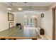 Home office with L-shaped desk and view of the sunroom and pool area at 1614 King James Ct, Lakeland, FL 33813
