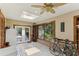 Bright sunroom with tile floors, access to the backyard, and plenty of natural light at 1614 King James Ct, Lakeland, FL 33813