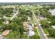An aerial view of the home and neighborhood shows the lake and proximity to recreational fields at 415 Avenue K Ne, Winter Haven, FL 33881