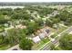 This aerial view shows a home with a metal roof and mature trees in a quiet residential neighborhood at 415 Avenue K Ne, Winter Haven, FL 33881