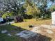 Spacious backyard with mature trees, a patio, and a shed at 415 Avenue K Ne, Winter Haven, FL 33881