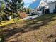 Spacious backyard with a large grassy area and mature trees at 415 Avenue K Ne, Winter Haven, FL 33881