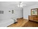 Bedroom with twin bed, hardwood floors, and a wooden dresser at 415 Avenue K Ne, Winter Haven, FL 33881