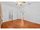 Bedroom with hardwood floors, ceiling fan, and access to an ensuite bathroom and spiral staircase at 415 Avenue K Ne, Winter Haven, FL 33881
