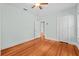 Bright bedroom with hardwood floors, closet, and open door to the Primary bathroom at 415 Avenue K Ne, Winter Haven, FL 33881