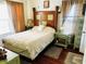 Bedroom with hardwood floors and a wood headboard at 415 Avenue K Ne, Winter Haven, FL 33881