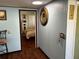 View of bedroom from hallway, showcasing wood floors and a bed at 415 Avenue K Ne, Winter Haven, FL 33881