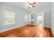 Neutral bedroom with hardwood floors, two bright windows, and a walk-in closet at 415 Avenue K Ne, Winter Haven, FL 33881