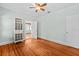 Bedroom with wooden floors, storage, and a connecting open door to another room at 415 Avenue K Ne, Winter Haven, FL 33881