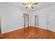 This bedroom features hardwood floors, a ceiling fan, and a neutral color scheme at 415 Avenue K Ne, Winter Haven, FL 33881