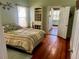 Bright bedroom with hardwood floors and built-in shelving at 415 Avenue K Ne, Winter Haven, FL 33881